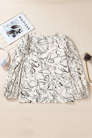 Ivory abstract scribble blouse with balloon sleeves and a round neckline.
