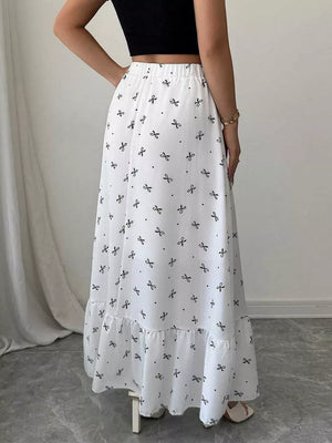 White maxi skirt with black bowknot print and ruffled hem.