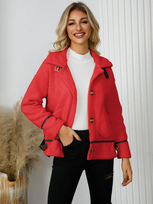 Red teddy-textured jacket with leatherette trim and buckle details.