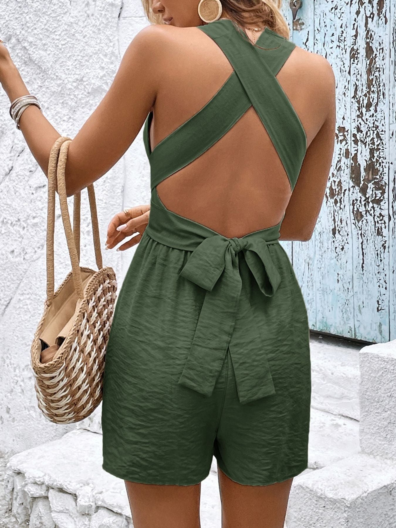 Moss green sleeveless romper with crisscross back and tie waist detail