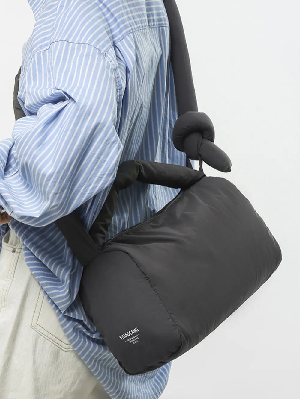 Padded knot shoulder bag in dark gray with a knotted strap detail.