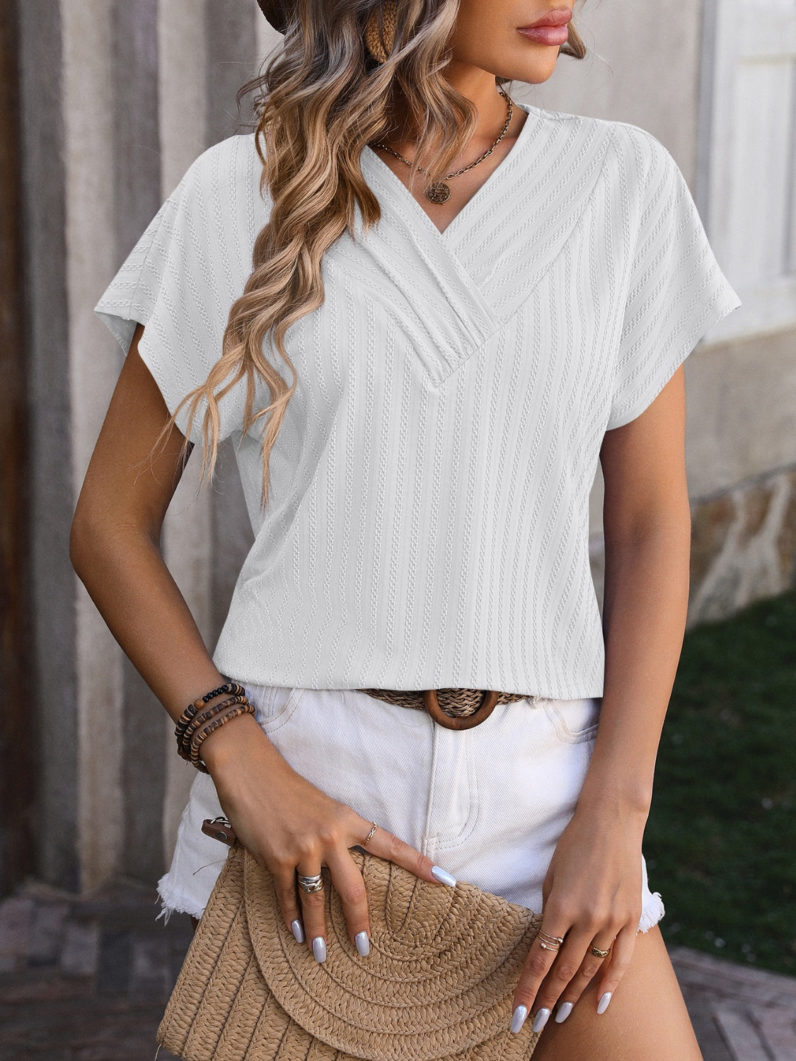 White textured V-neck tee with short sleeves and a surplice detail.