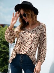 Beige dotted print blouse with balloon sleeves and v-neck.
