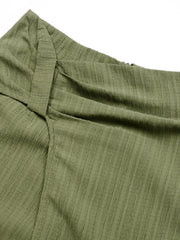 Matcha green skort shorts with draped knot front detail and textured fabric.