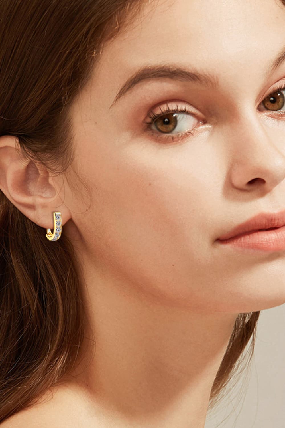 Gold pavé-set hoop earrings with clear stones, a chic accessory.
