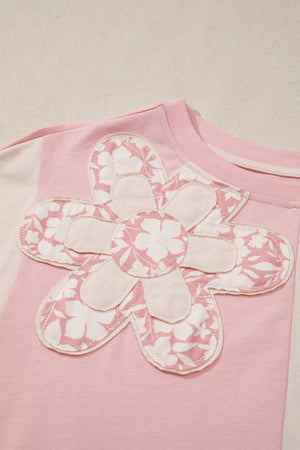 Pink cotton t-shirt with a large applique flower featuring a floral print and cream accents.