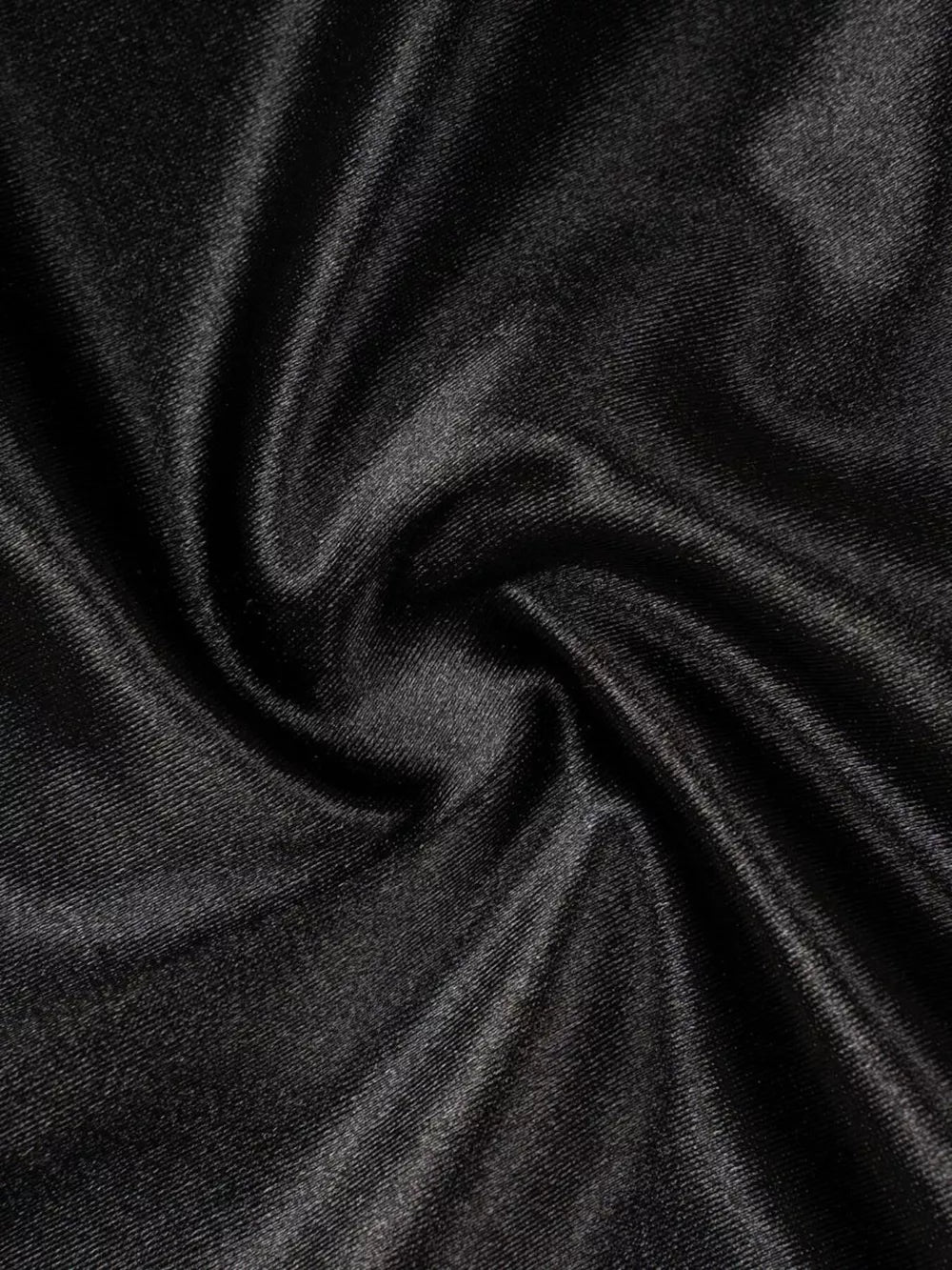 Black satin maxi skirt fabric detail with soft sheen and subtle texture.