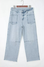 Light wash denim jeans with raw hem and large utility pockets.