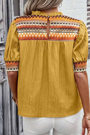 Mustard yellow blouse with embroidered yoke and puff sleeves, featuring a keyhole back detail.