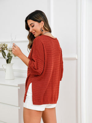 Rust textured knit sweater with boat neck and slit hem detail.