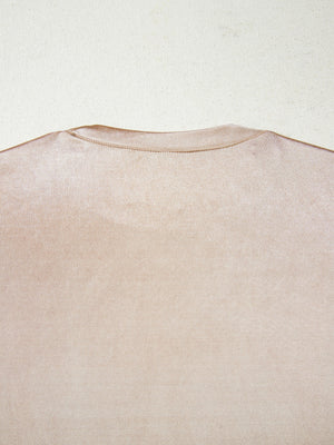 Sleeveless champagne tank top with a lustrous metallic finish and crew neckline.