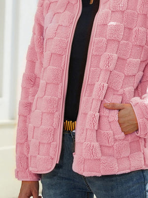 Textured grid zip-up jacket in blush pink with a fuzzy finish and zippered pockets.