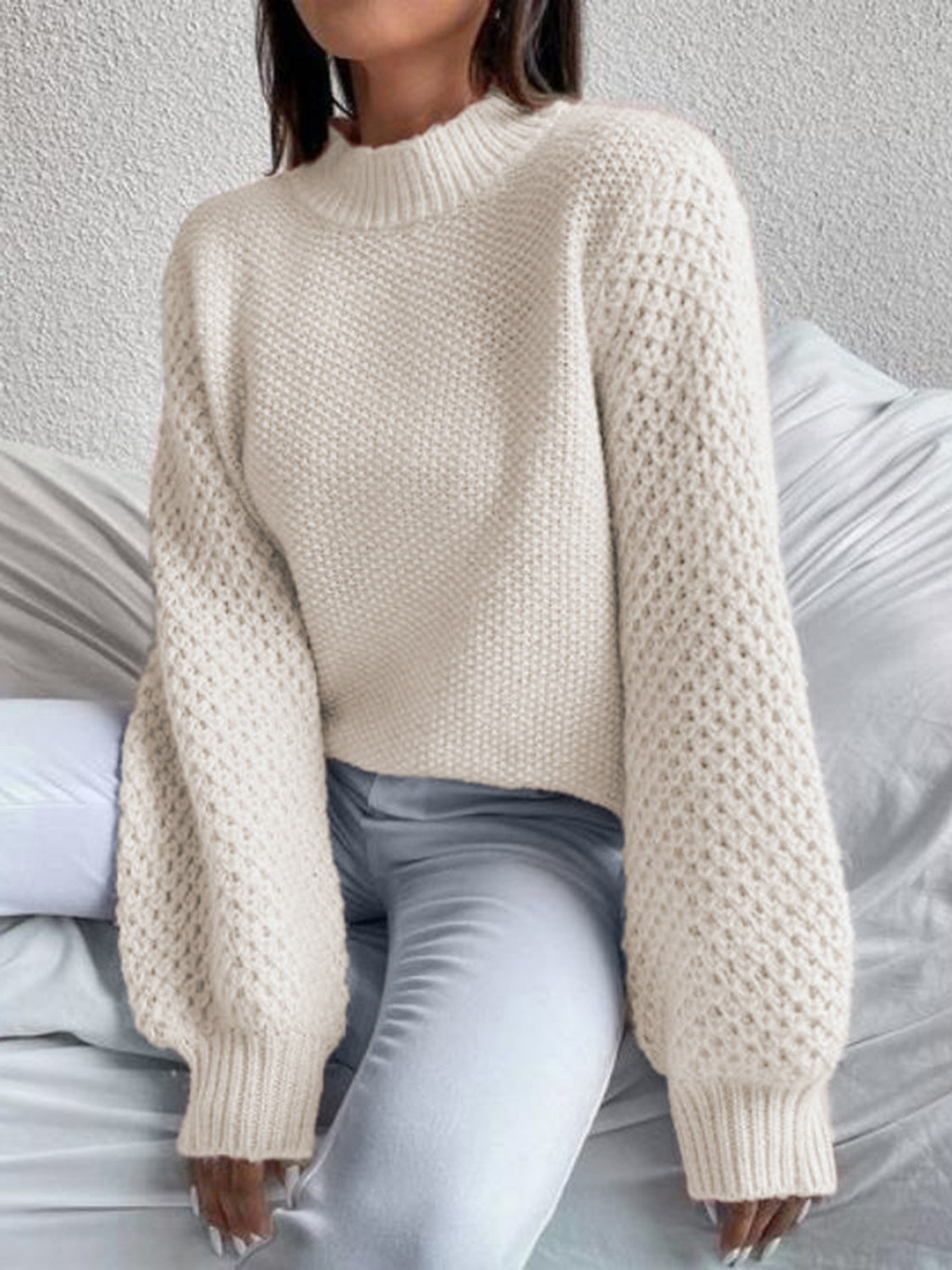 Cream textured puff sleeve mock neck knit sweater with waffle knit detail.