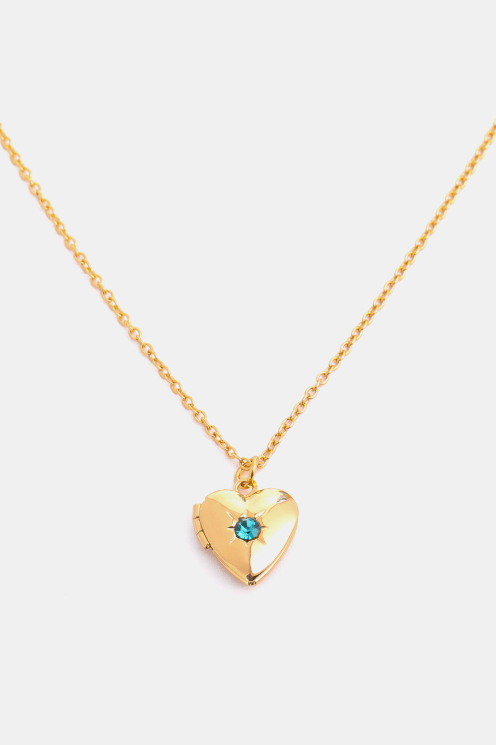 Gold heart locket necklace with blue gemstone and chain