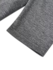 Dark gray crew neck pajama set detail showing hem stitching on soft fabric.