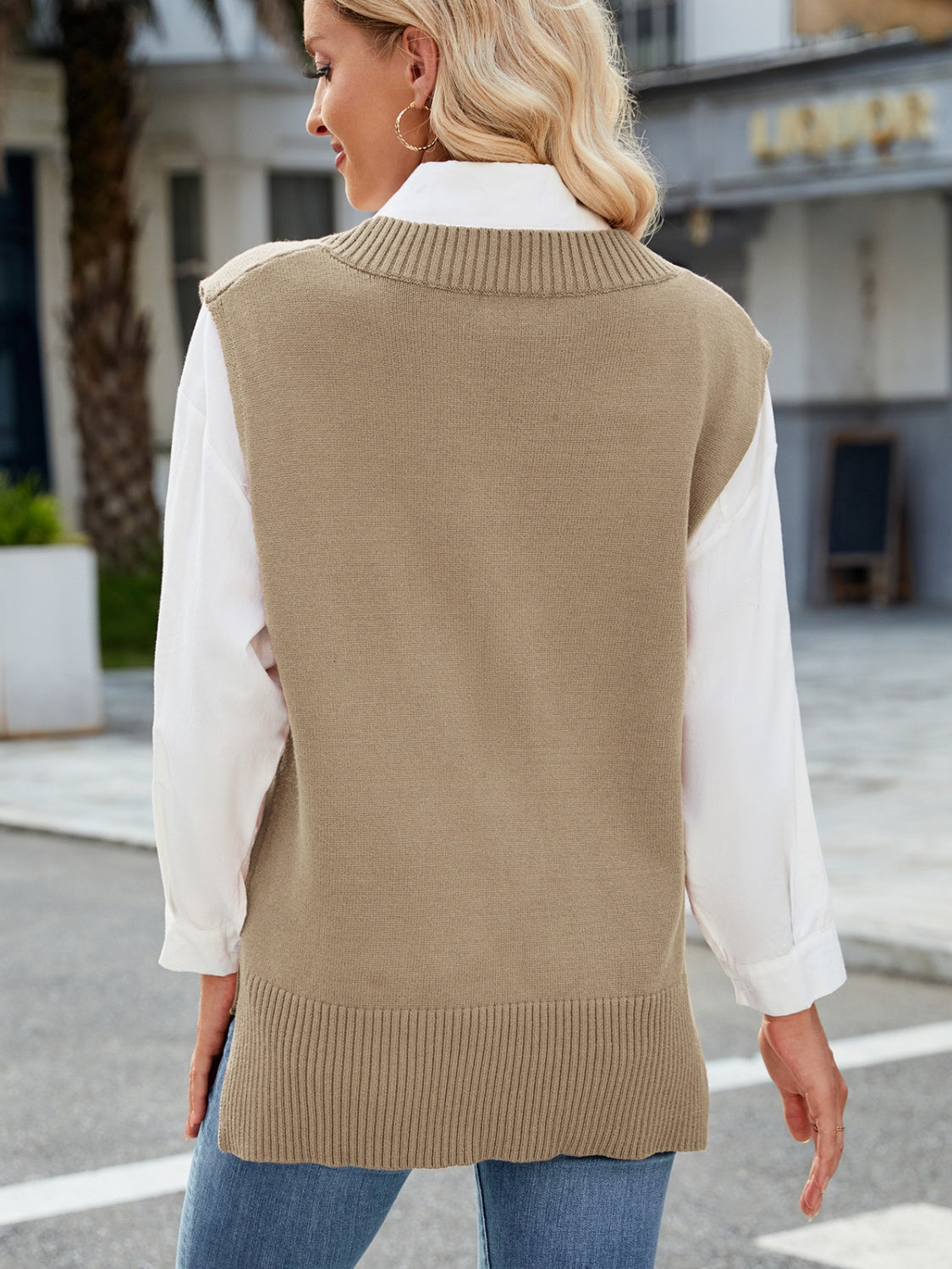 Ribbed knit V-neck sweater vest in Khaki with a relaxed fit, styled over a white shirt.