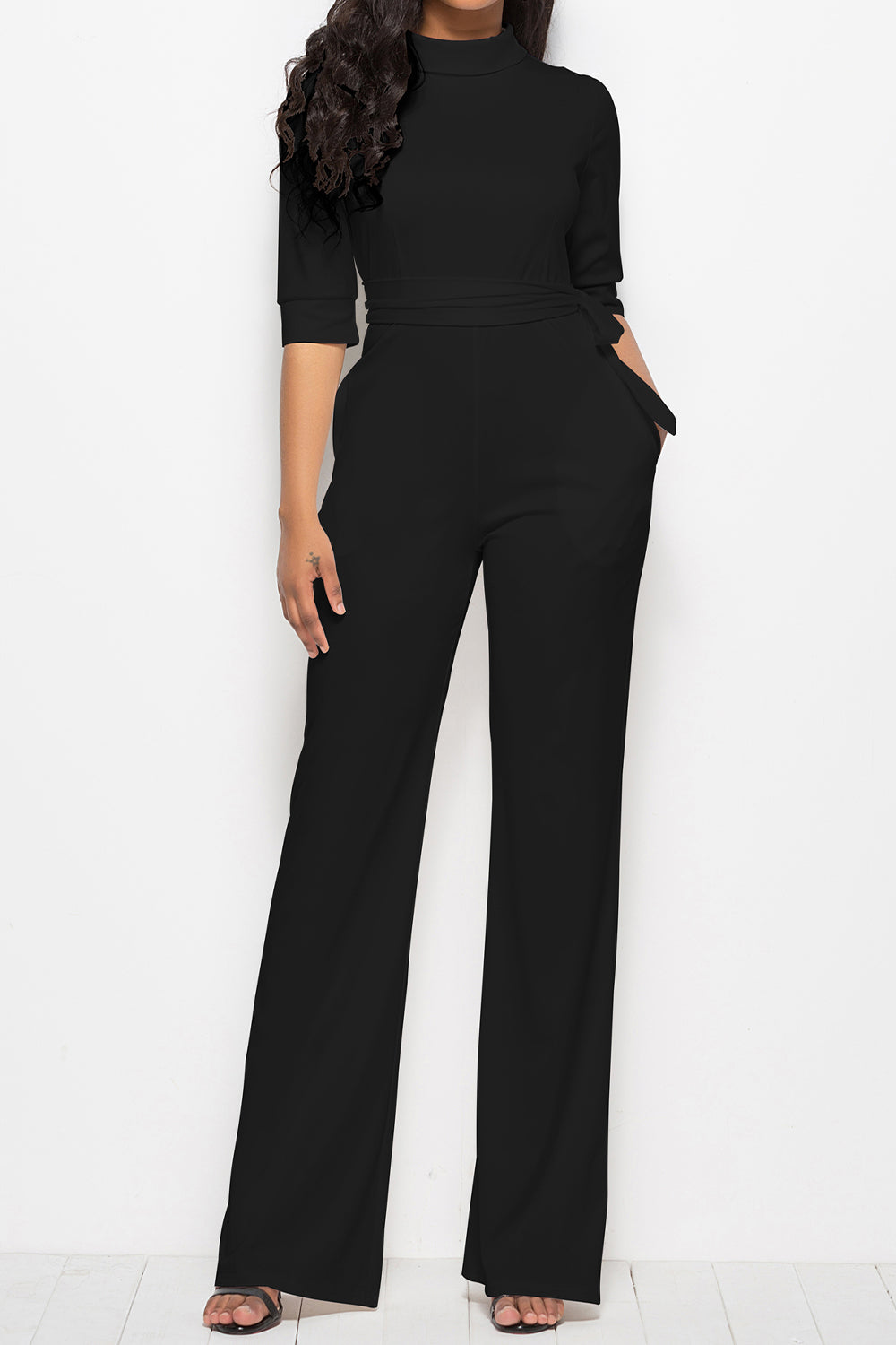 Black high-neck belted palazzo jumpsuit with 3/4 sleeves and wide legs.