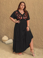 Black plus size maxi dress with V-neck and floral embroidery, ruffled hem