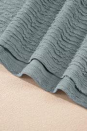 Textured crew neck t-shirt in air force blue with cap sleeves and a crinkled fabric detail.
