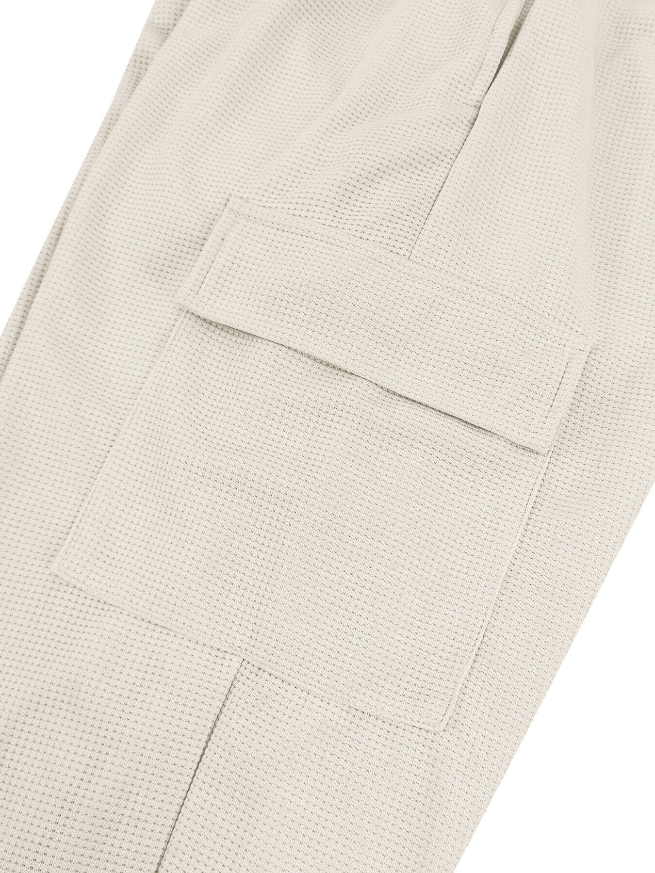 Textured waffle knit joggers in light gray with a cargo pocket detail.