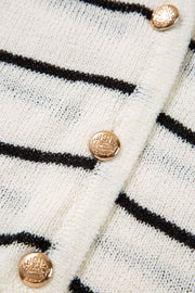 White knit vest with black nautical stripes and gold button details.