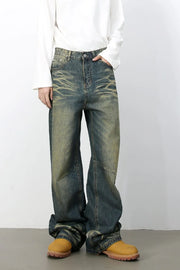 Distressed denim wide-leg trousers in medium wash with faded details and a relaxed fit.