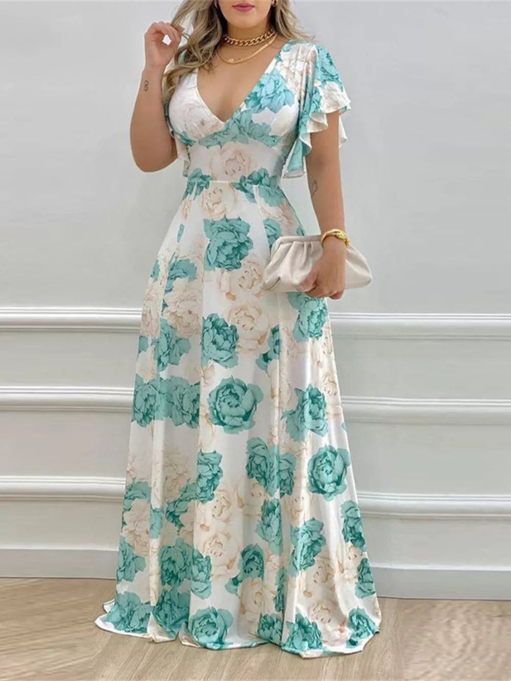 Floral V-neck maxi dress with ruffle sleeves in white with teal and cream roses.