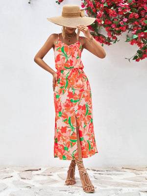 Floral print midi dress with button-down front, spaghetti straps, elastic waist, and thigh-high slit.