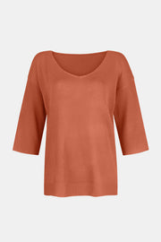 Orange knit sweater with V-neck and flared 3/4 sleeves.