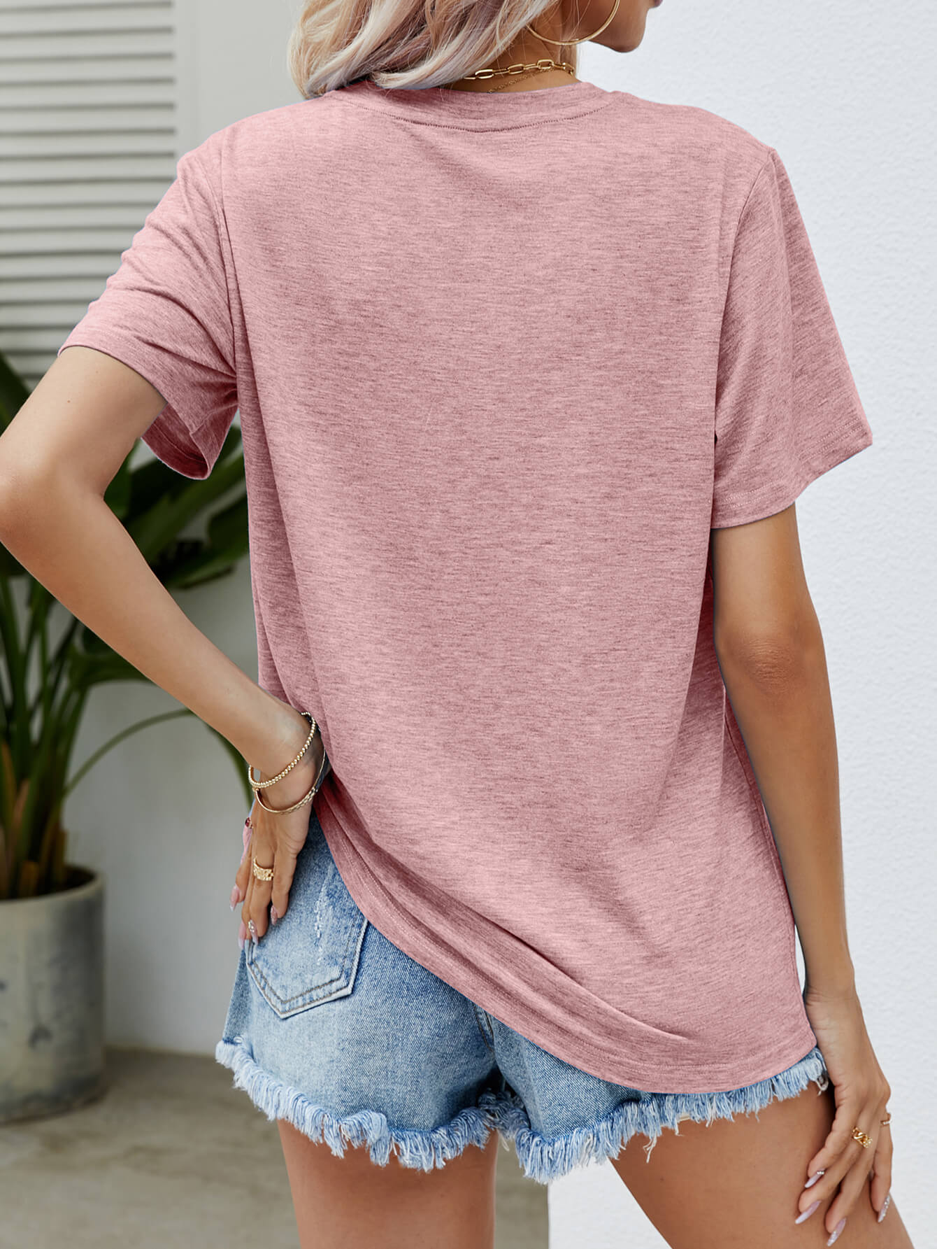 Dusty Pink heather t-shirt with short sleeves and a relaxed fit, styled with denim shorts.