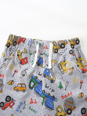Toddler grey shorts with playful construction vehicle print and white drawstring waist.