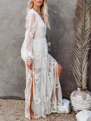 White floral lace maxi dress with long sleeves, V-neck, and high slits.