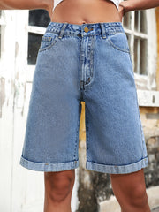 Light wash denim bermuda shorts with button fly and rolled hems.