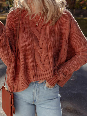 Chunky oversized cable-knit sweater in rust, with a cropped length and textured acrylic blend.