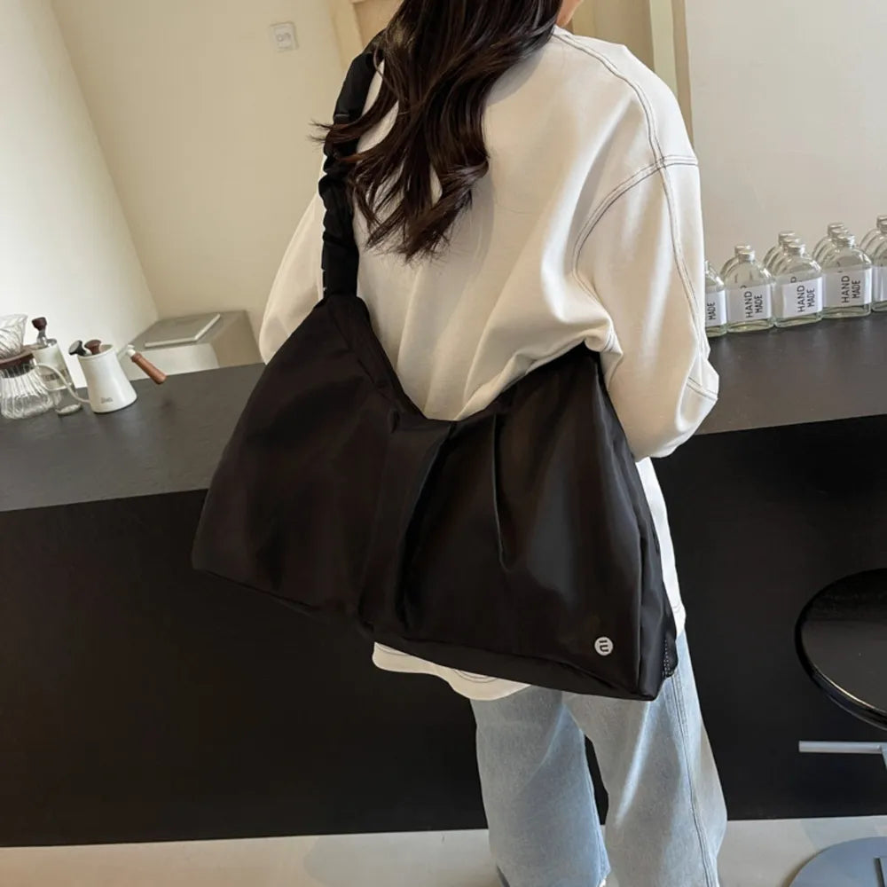 Black canvas ruched handle crescent shoulder bag with a casual style.