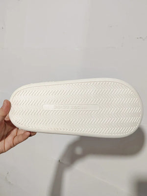 White faux fur house slides sole with chevron tread pattern and size marking