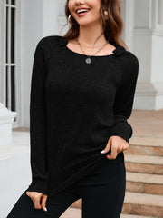 Black textured knit top with raglan sleeves and a scoop neckline, featuring subtle ribbed detail.