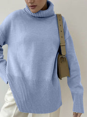 Light blue ribbed turtleneck sweater with flared sleeves and a textured hem.