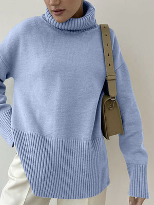 Light blue ribbed turtleneck sweater with flared sleeves and a textured hem.
