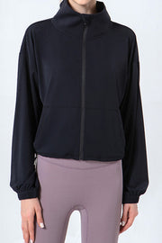 Black active jacket with gathered hemline, high neck, and full zip.