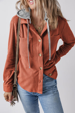 Orange-Red corduroy shirt jacket with contrast gray hood and button front.