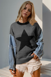 Dark gray knit sweater with black star and denim sleeves.