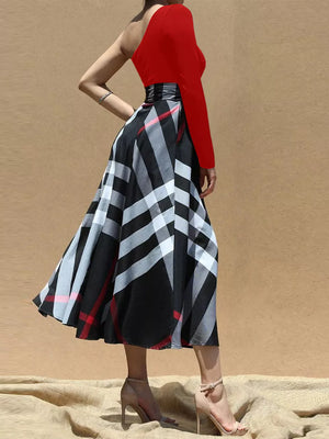 Red one-shoulder midi dress with a black and white plaid belted skirt.