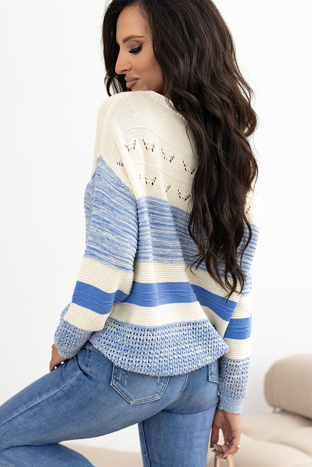 Striped knit sweater in light blue and cream with eyelet yoke detail and crochet hem.