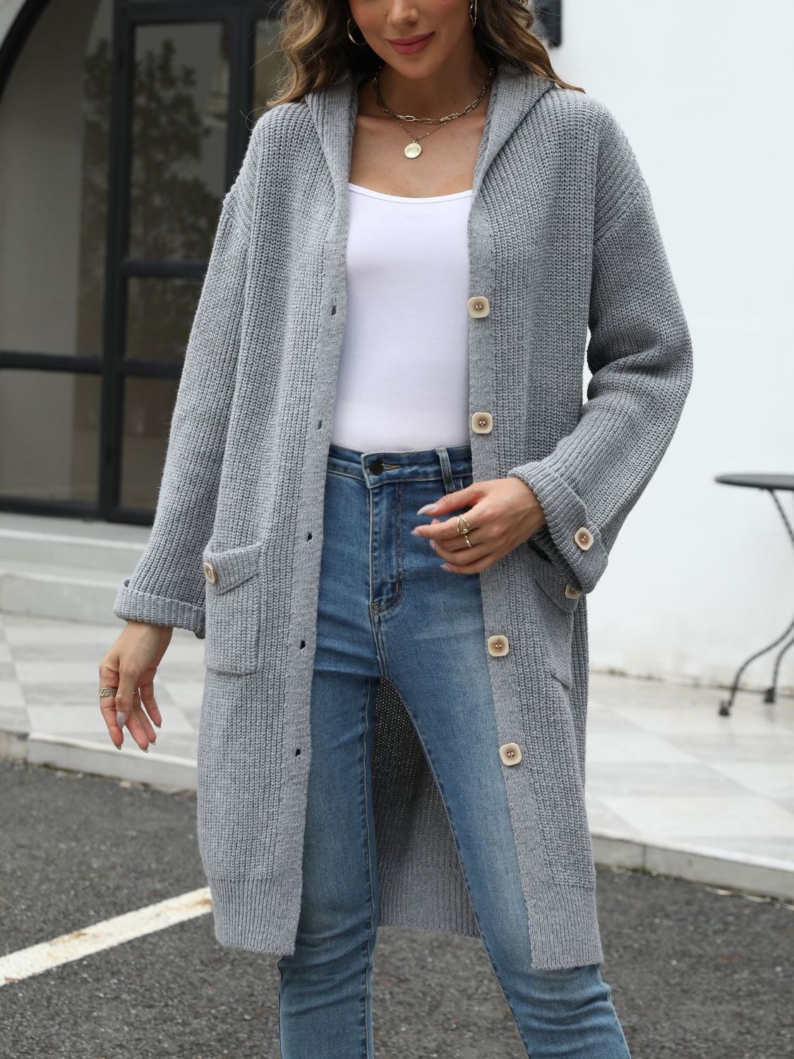 Longline gray knit button-down cardigan with hood and pockets.