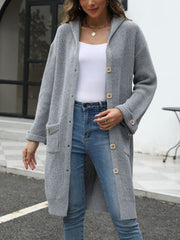Longline gray knit button-down cardigan with hood and pockets.
