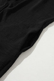 Black oversized shirt romper with side pockets