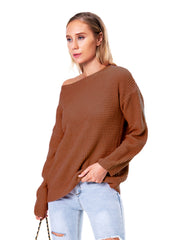 Off-shoulder waffle knit sweater in chestnut acrylic, styled casually with jeans.