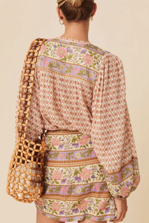 Bohemian print blouson sleeve top in floral with diamond and stripe patterns.
