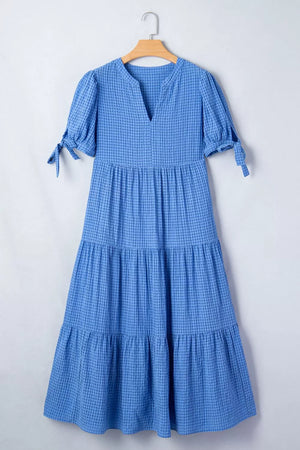 Blue tiered midi dress with notched neckline and tie-sleeve detail